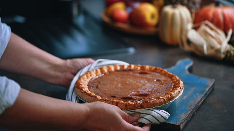 Pumpkin pie placed on cutting board