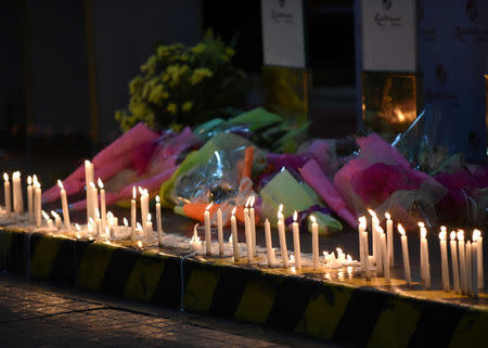 FILE PHOTO: Lighted candles and flowers are pictured outside Resorts World during a memorial for those killed in a casino fire caused by a gunman in Pasay City, Metro Manila Philippines June 2, 2017. REUTERS/Dondi Tawatao