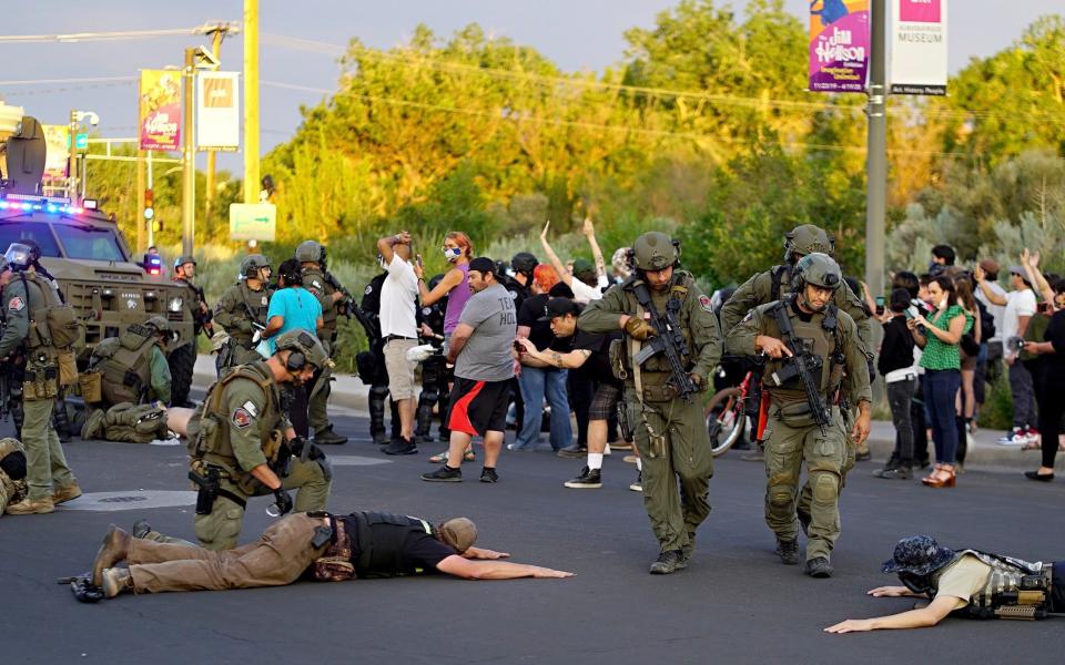 A confrontation erupted between protesters and a group of armed men who were trying to protect a statue of a Spanish conquerer - The Albuquerque Journal 