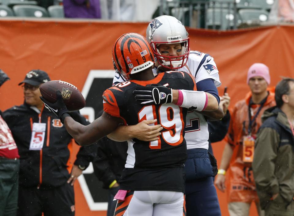 OCT. 6, 2013: Cincinnati Bengals wide receiver Brandon Tate (19) and New England Patriots quarterback Tom Brady (12) greet each other prior to their game at Paul Brown Stadium.