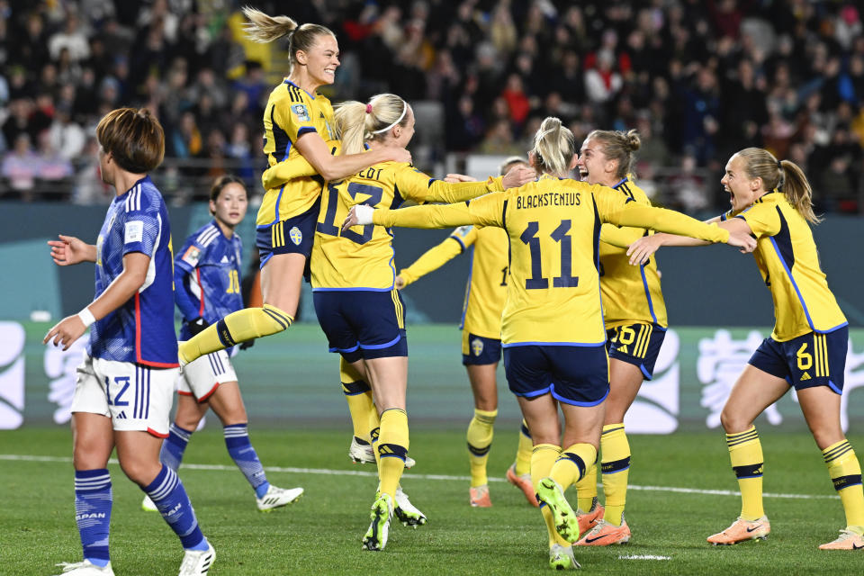 Sweden's Amanda Ilestedt, center, is congratulated by teammates after scoring her team's first goal during the Women's World Cup quarterfinal soccer match between Japan and Sweden at Eden Park in Auckland, New Zealand, Friday, Aug. 11, 2023. (AP Photo/Andrew Cornaga)