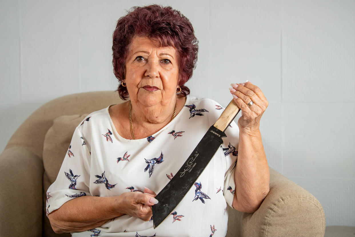 Shirley McNally with the machete that she found under her sofa at her home in Harlow, Essex. 