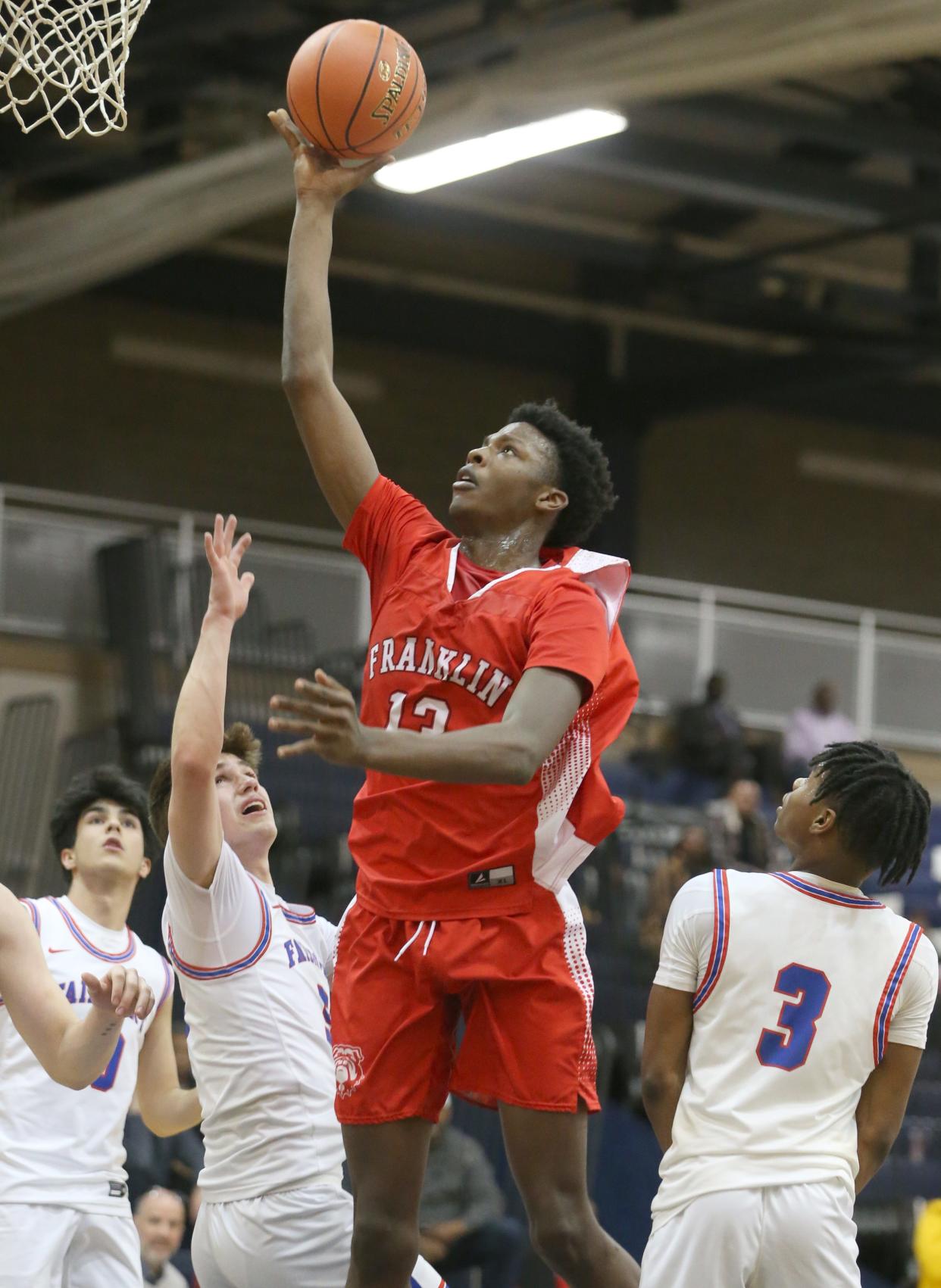 Franklin's Terence Thompson scores over a crowded lane in the first half.