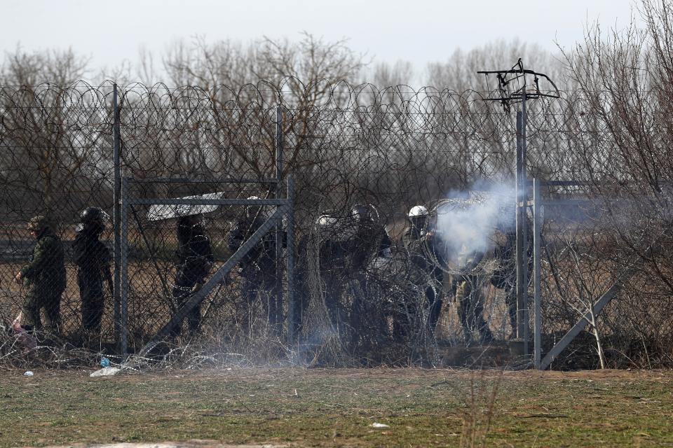 Greek police fires tear gas at migrants who trying to enter Greece during clashes at the Turkish-Greek border near the Pazarkule border gate in Edirne, Turkey on Monday, March 2, 2020.Thousands of migrants and refugees massed at Turkey's western frontier, trying to enter Greece by land and sea after Turkey said its borders were open to those hoping to head to Europe. (AP Photo/Darko Bandic)