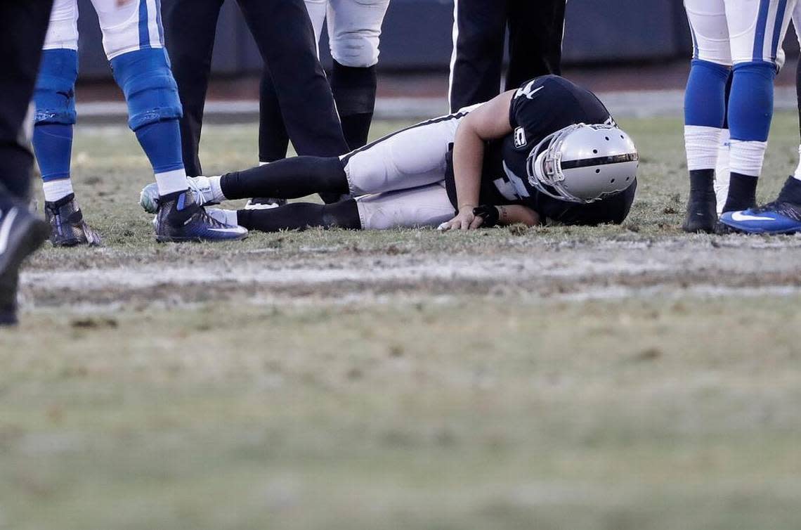 Raiders quarterback Derek Carr lays on the field after breaking his right fibula in Oakland on Saturday, Dec. 24, 2016.