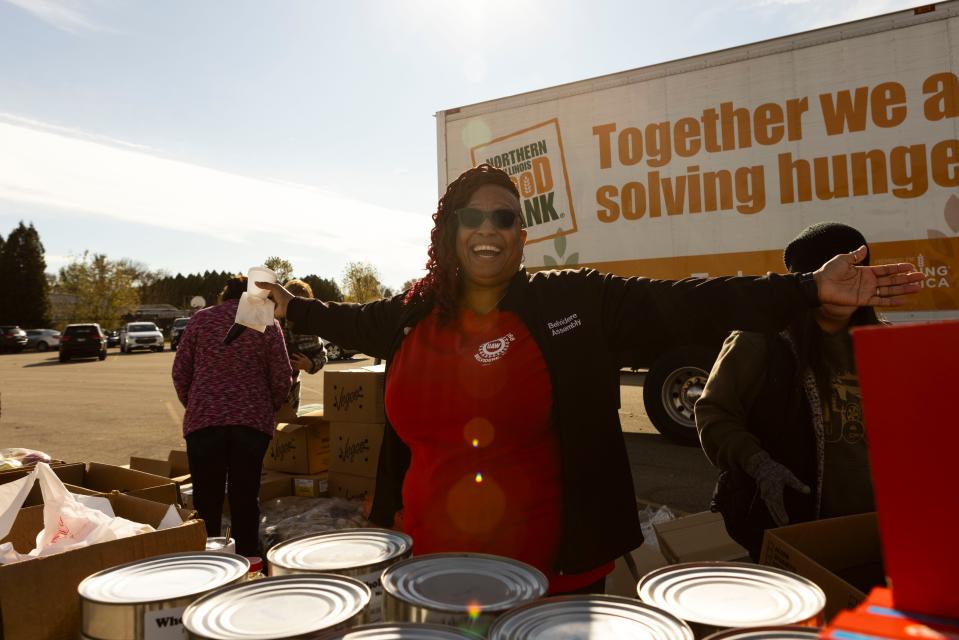 Nichelle Cruz, a 29-year Belvidere Assembly Plant veteran and UAW Local 1268 union member, gestures to volunteers during a Wednesday, Nov. 1, 2023, food, winter clothes and supply event for the local community after reaching a tentative agreement with Stellantis.