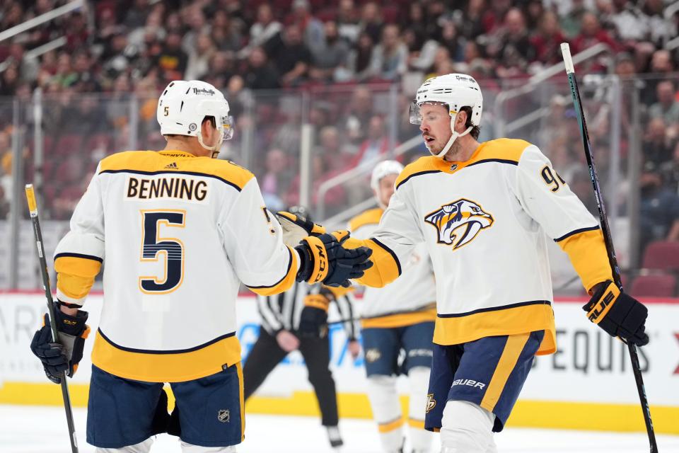 Apr 29, 2022; Glendale, Arizona, USA; Nashville Predators center Ryan Johansen (92) celebrates his goal with Nashville Predators defenseman Matt Benning (5) against the Arizona Coyotes during the first period at Gila River Arena. Mandatory Credit: Joe Camporeale-USA TODAY Sports