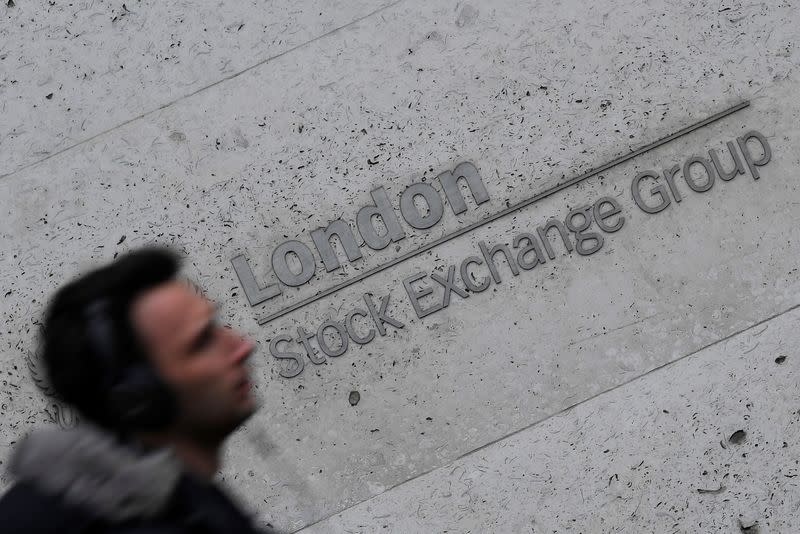 People walk past the London Stock Exchange Group offices in the City of London, Britain