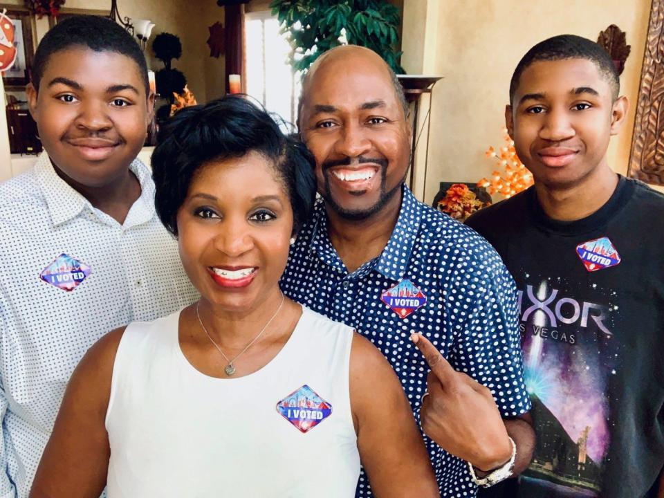 Wendy and Allen Shelton and sons Christian and Allen Jr. pose with their "I voted" stickers after an early-voting event.