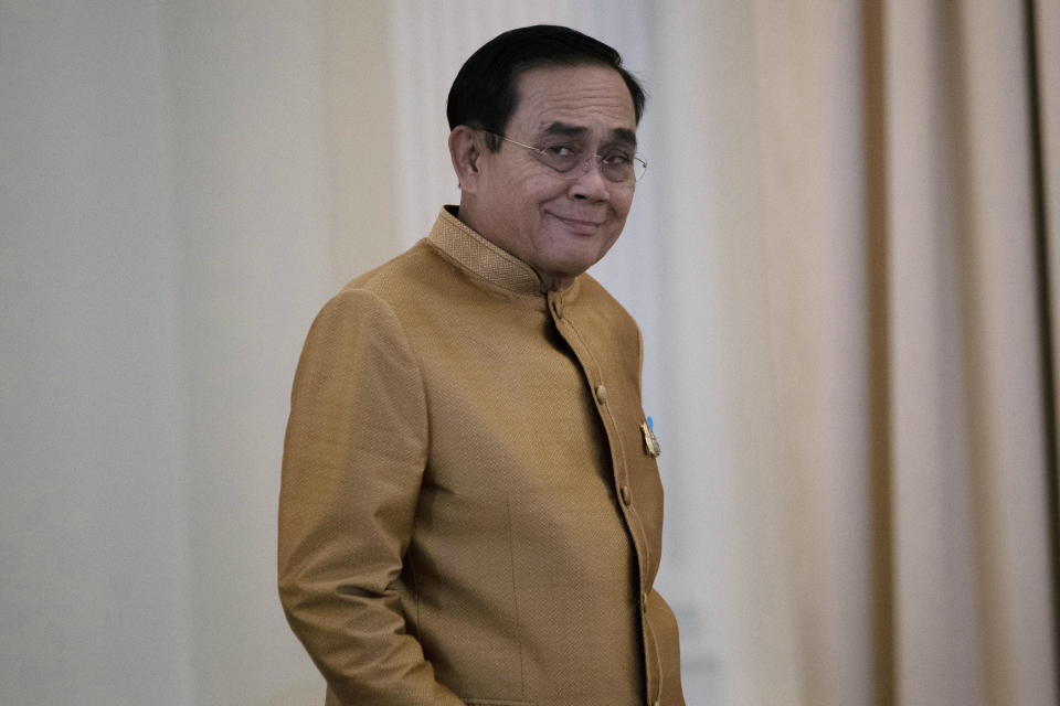 Thailand's Prime Minister Prayuth Chan-ocha arrives to speak to the media during a press conference at Government House in Bangkok, Thailand, Tuesday, Dec. 1, 2020. Thailand’s highest court is set to rule Wednesday, Dec. 2, 2020 on whether Prayuth has breached ethics clauses in the country’s constitution and should be ousted from his position. (AP Photo/Sakchai Lalit)