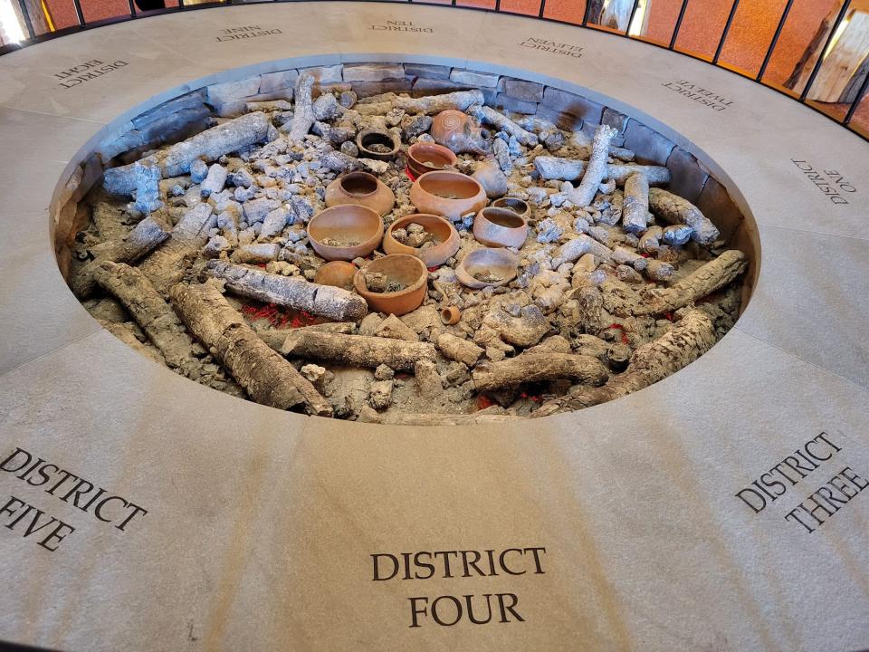 The entrance of the Choctaw Cultural Center simulates a traditional Choctaw home, or "Chukka," with a central fireplace. The hearth boasts one stone for each of the Choctaw Nation’s 12 districts, and it’s ringed by sleek wooden seats.