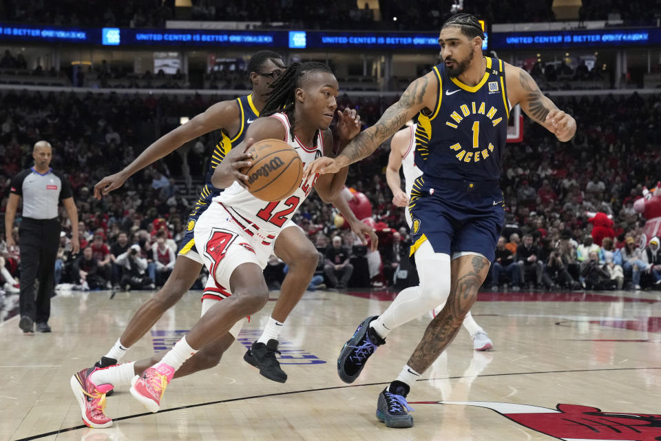 Chicago Bulls guard Ayo Dosunmu, left, drives against Indiana Pacers forward Obi Toppin during the first half of an NBA basketball game in Chicago, Wednesday, March 27, 2024. (AP Photo/Nam Y. Huh)