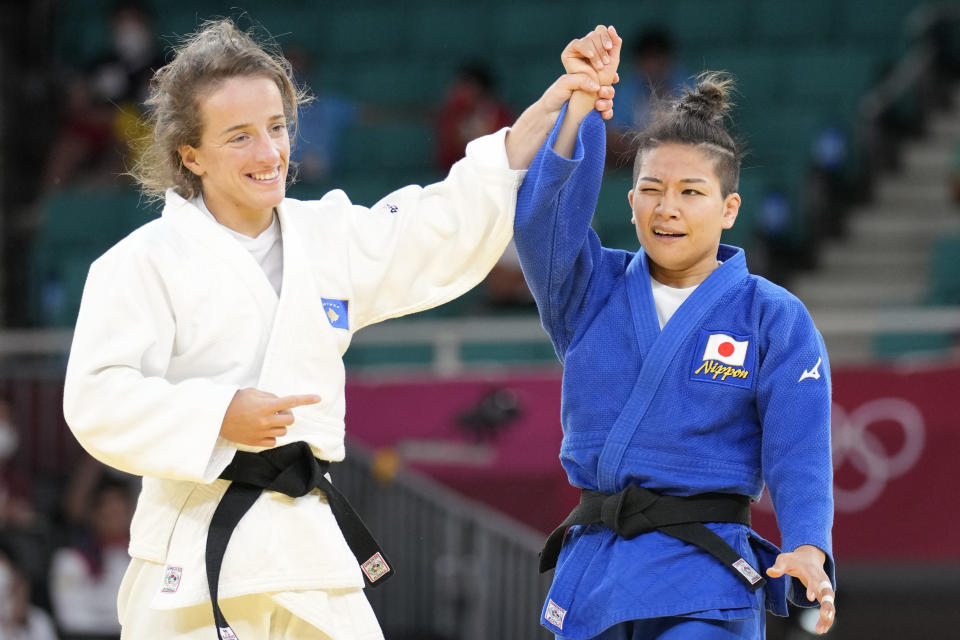 Distria Krasniqi of Kosovo, left, and Funa Tonaki of Japan react after competing in their women's -48kg championship judo match at the 2020 Summer Olympics, Saturday, July 24, 2021, in Tokyo, Japan. (AP Photo/Vincent Thian)