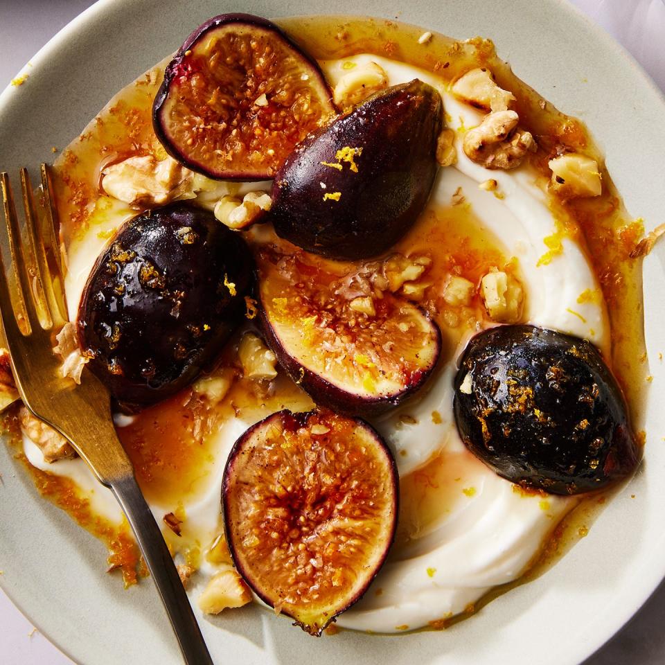 greek yogurt on a plate topped with honey, sliced figs and nuts