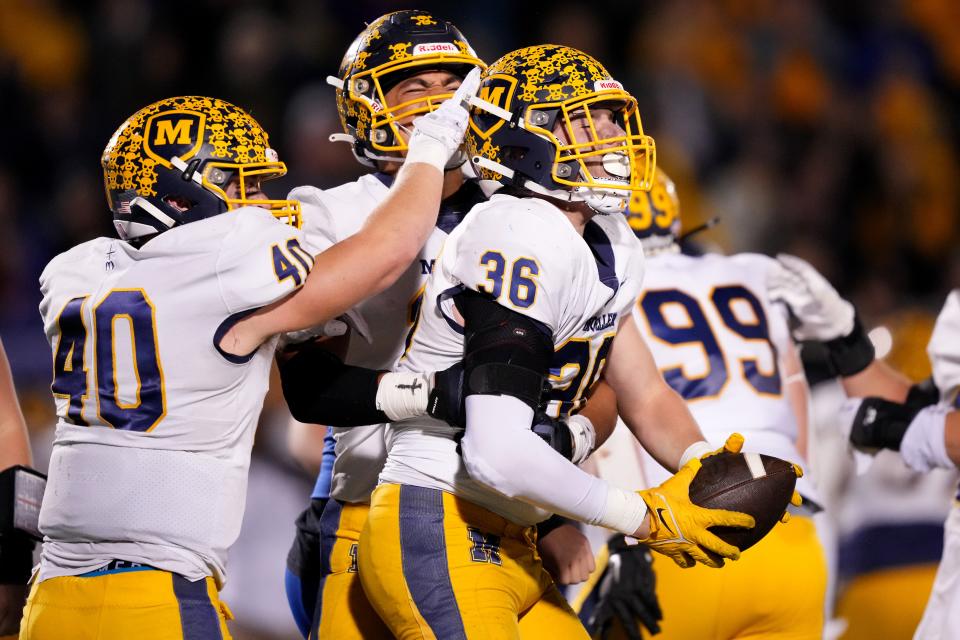 Moeller Crusaders linebacker Connor Cuozzo (36) celebrates with Moeller Crusaders defensive end Jewett Hayes (15) and Moeller Crusaders linebacker Kyler Paul (40) after a fumble recovery in the first half of a second-round Division I OHSAA high school football game against the St. Xavier Bombers, Friday, Nov. 3, 2023, at St. Xavier High School’s RDI Field in Cincinnati.