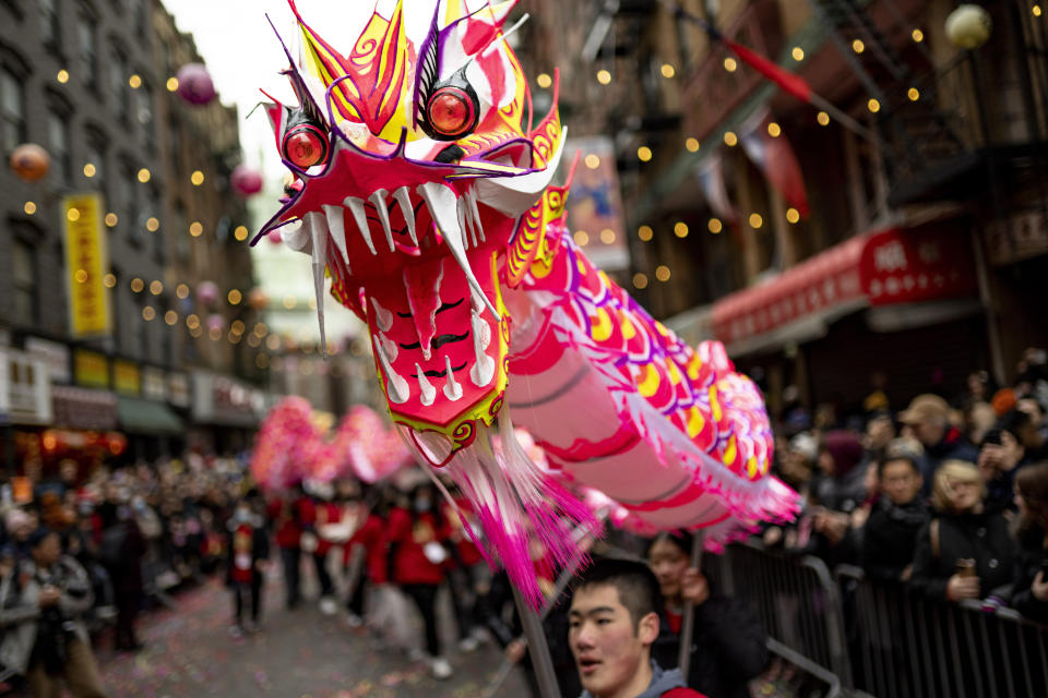 FILE - Revelers celebrate Lunar New Year in Manhattan's Chinatown, Feb. 12, 2023, in New York. On Feb. 10, 2024 Asian American communities around the U.S. will ring in the Year of the Dragon with community carnivals, family gatherings, parades, traditional food, fireworks and other festivities. In many Asian countries, it is a festival that is celebrated for several days. In diaspora communities, particularly in cultural enclaves, Lunar New Year is visibly and joyfully celebrated. (AP Photo/John Minchillo, file)