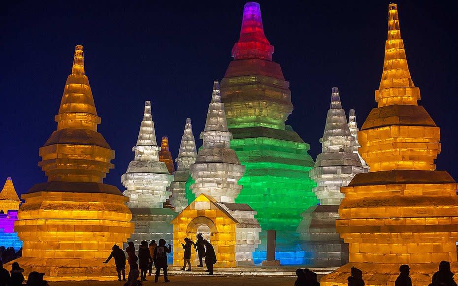 <p>Ice temples illuminated by colored lights at the Harbin Ice and Snow Festival to celebrate the new year in China.</p>