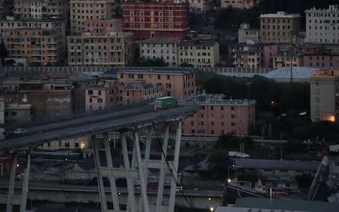A truck is seen at the collapsed Morandi Bridge site in the port city of Genoa, Italy  - Credit: Reuters