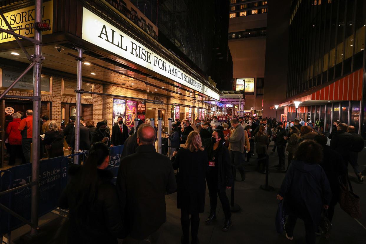 People wearing protective masks wait in line to attend an evening performance of "To Kill a Mockingbird" at the Shubert Theatre in Manhattan, New York. 