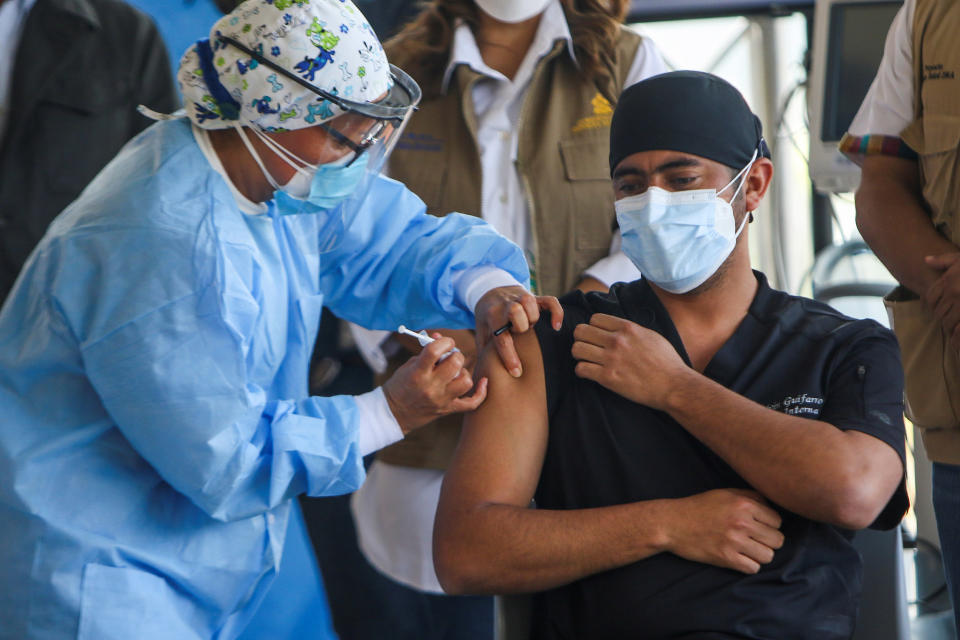 Image: Health worker Nolvin Guifarro receives a dose of the Moderna Covid-19 vaccine at the Hospital Maria, in Tegucigalpa, Honduras (Reuters)