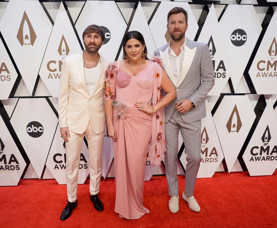Dave Haywood, from left, Hillary Scott and Charles Kelley of Lady A arrive at the 55th annual CMA Awards in Nashville, Tenn., on  Nov. 10, 2021. (AP Photo/Ed Rode, File)
