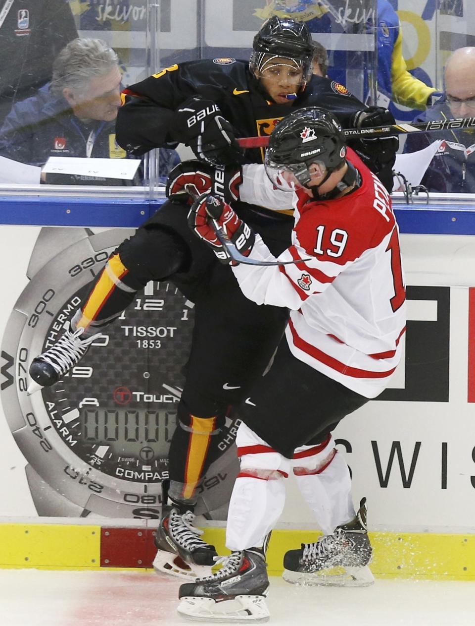 Canada's Petan checks Germany's Laub during the third period of their IIHF World Junior Championship ice hockey game in Malmo