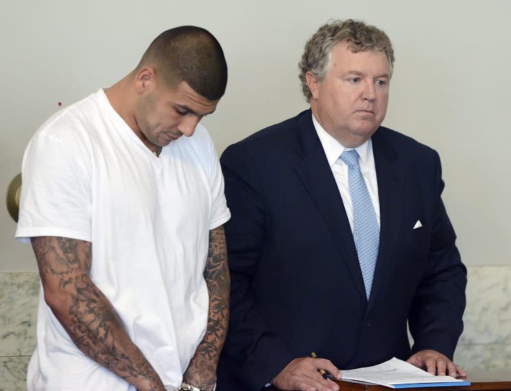 Aaron Hernandez hangs his head during his arraignment for the murder of Odin Lloyd in 2013. (AP)