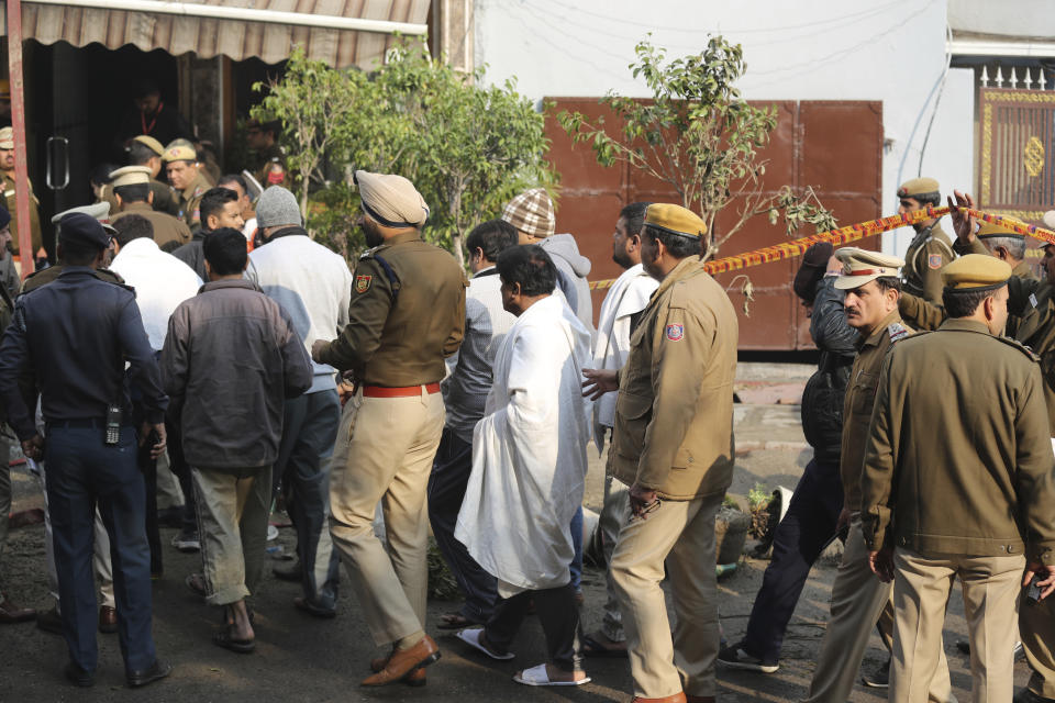 Hotel guests arrive to identify their belongings after an early morning fire killed more than a dozen people at the Arpit Palace Hotel in the Karol Bagh neighborhood of New Delhi, India, Tuesday, Feb.12, 2019. (AP Photo/Manish Swarup)