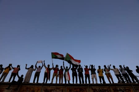 FILE PHOTO: Sudanese protesters attend a demonstration in front of the defense ministry compound in Khartoum