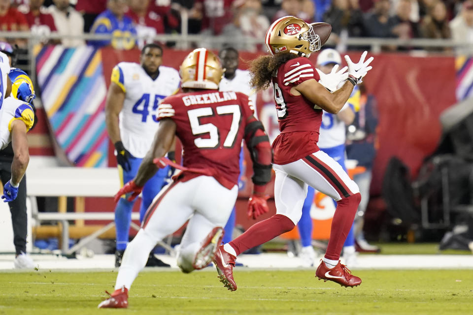 San Francisco 49ers safety Talanoa Hufanga, right, returns an interception for a touchdown during the second half of an NFL football game against the Los Angeles Rams in Santa Clara, Calif., Monday, Oct. 3, 2022. (AP Photo/Godofredo A. Vásquez)