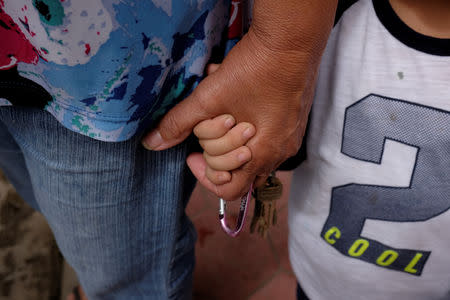 Iris Olivo holds her grandson Andrew Miranda's hand at the slum of La Vega in Caracas, Venezuela November 16, 2018. Picture taken November 16, 2018. REUTERS/Marco Bello