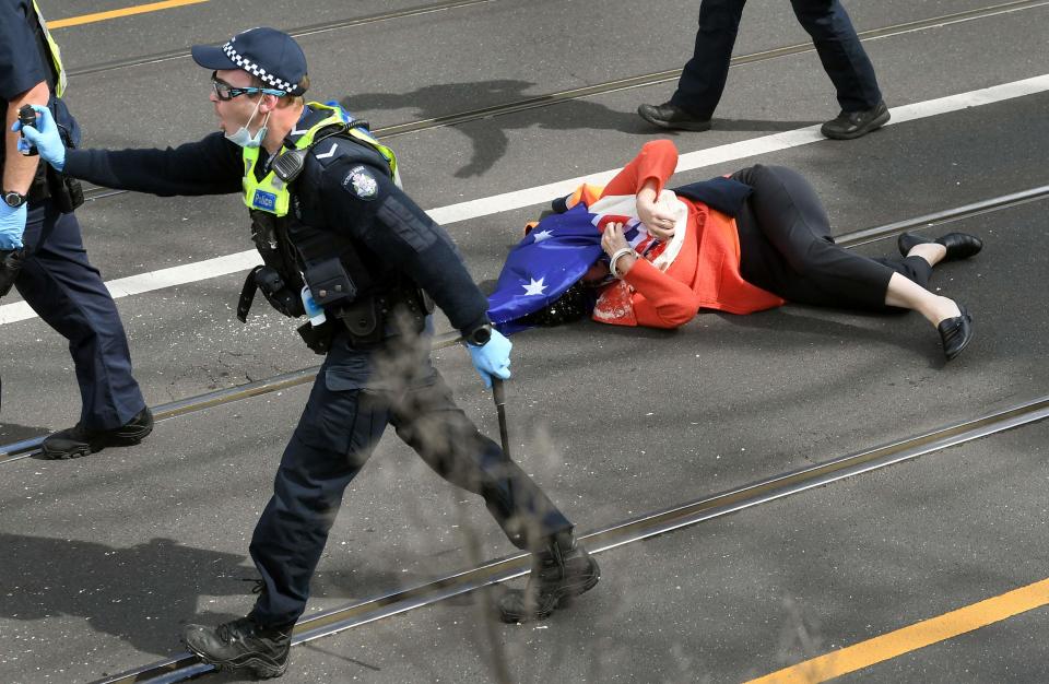 A protester who was pushed to the ground by the police after being pepper sprayed (AFP/Getty)