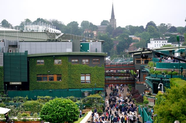 Spectators walk around the grounds