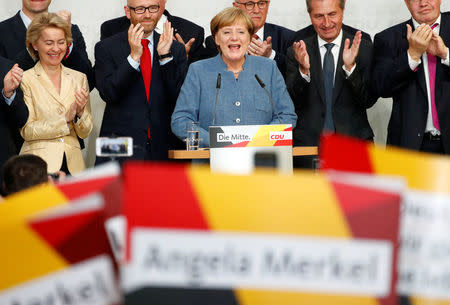 Christian Democratic Union (CDU) party leader and German Chancellor Angela Merkel reacts on first exit polls in the German general election (Bundestagswahl) in Berlin, Germany, September 24, 2017. REUTERS/Fabrizio Bensch