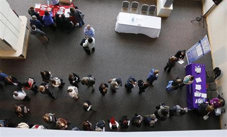 Hundreds of job seekers wait in line with their resumes to talk to recruiters (right) at the Colorado Hospital Association health care career fair in Denver April 9, 2013. REUTERS/Rick Wilking