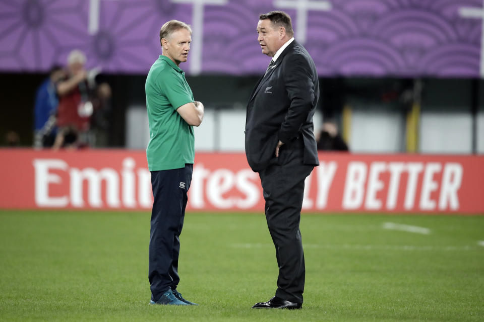 Ireland coach Joe Schmidt, left, talks to New Zealand coach Steve Hansen before the Rugby World Cup quarterfinal match at Tokyo Stadium between New Zealand and Ireland in Tokyo, Japan, Saturday, Oct. 19, 2019. (AP Photo/Jae Hong)