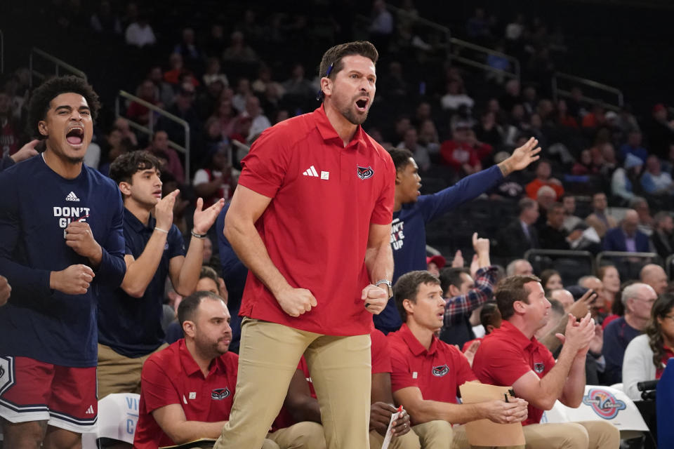 Florida Atlantic coaches and players celebrate a 3-point basket against Illinois during the first half of an NCAA college basketball game in New York, Tuesday, Dec. 5, 2023. (AP Photo/Peter K. Afriyie)