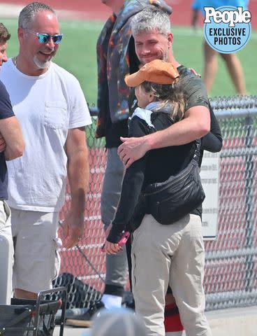 MEGA / BACKGRID Ant Anstead holds Renée Zellweger following a soccer win