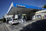 Drivers refuel at a Chevron gas station, Monday, Oct. 23, 2023, in South Miami, Fla. Chevron is buying Hess Corp. for $53 billion and it's not even the biggest acquisition in the energy sector this month as major producers seize the initiative while oil prices surge.(AP Photo/Rebecca Blackwell)