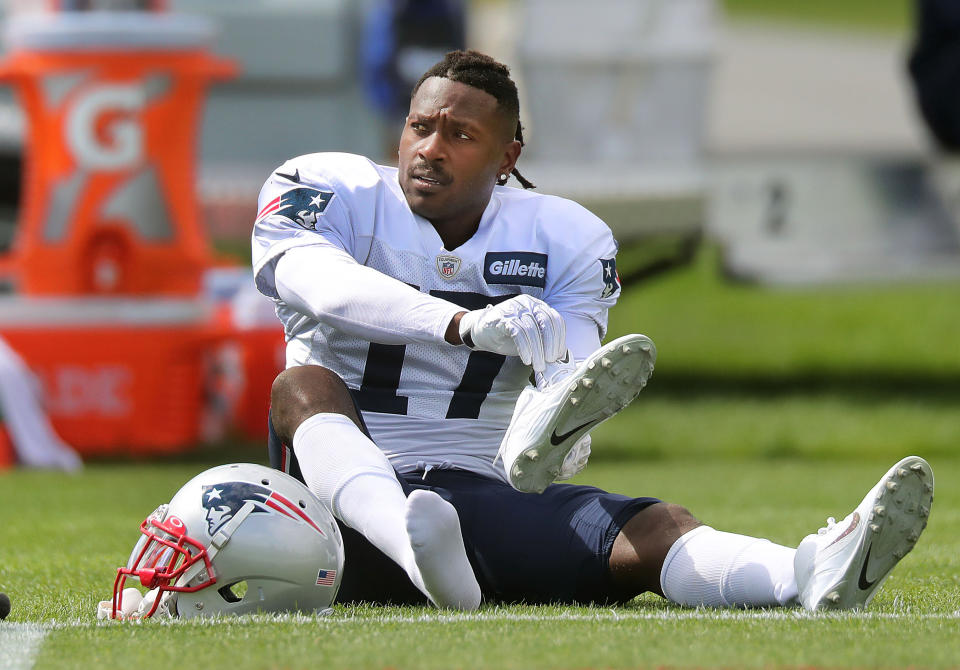 FOXBOROUGH, MA - SEPTEMBER 18: New England Patriots wide receiver Antonio Brown puts on his shoes on the field during New England Patriots practice at Gillette Stadium in Foxborough, MA on Sep. 18, 2019. (Photo by John Tlumacki/The Boston Globe via Getty Images)