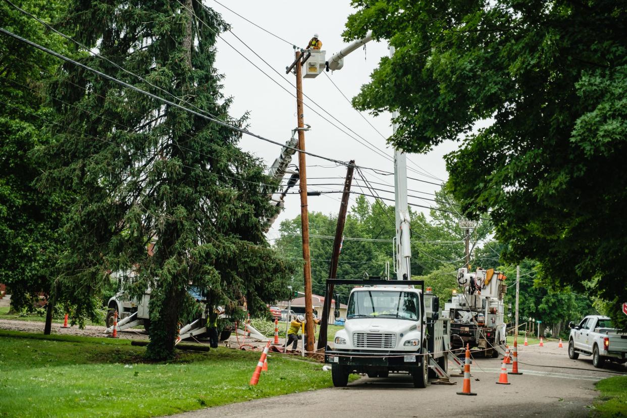 Crews work to install a new power pole in downtown Gnadenhutten, Tuesday, June 14. Multiple homes were damaged as a result to two known overnight or early morning storms.