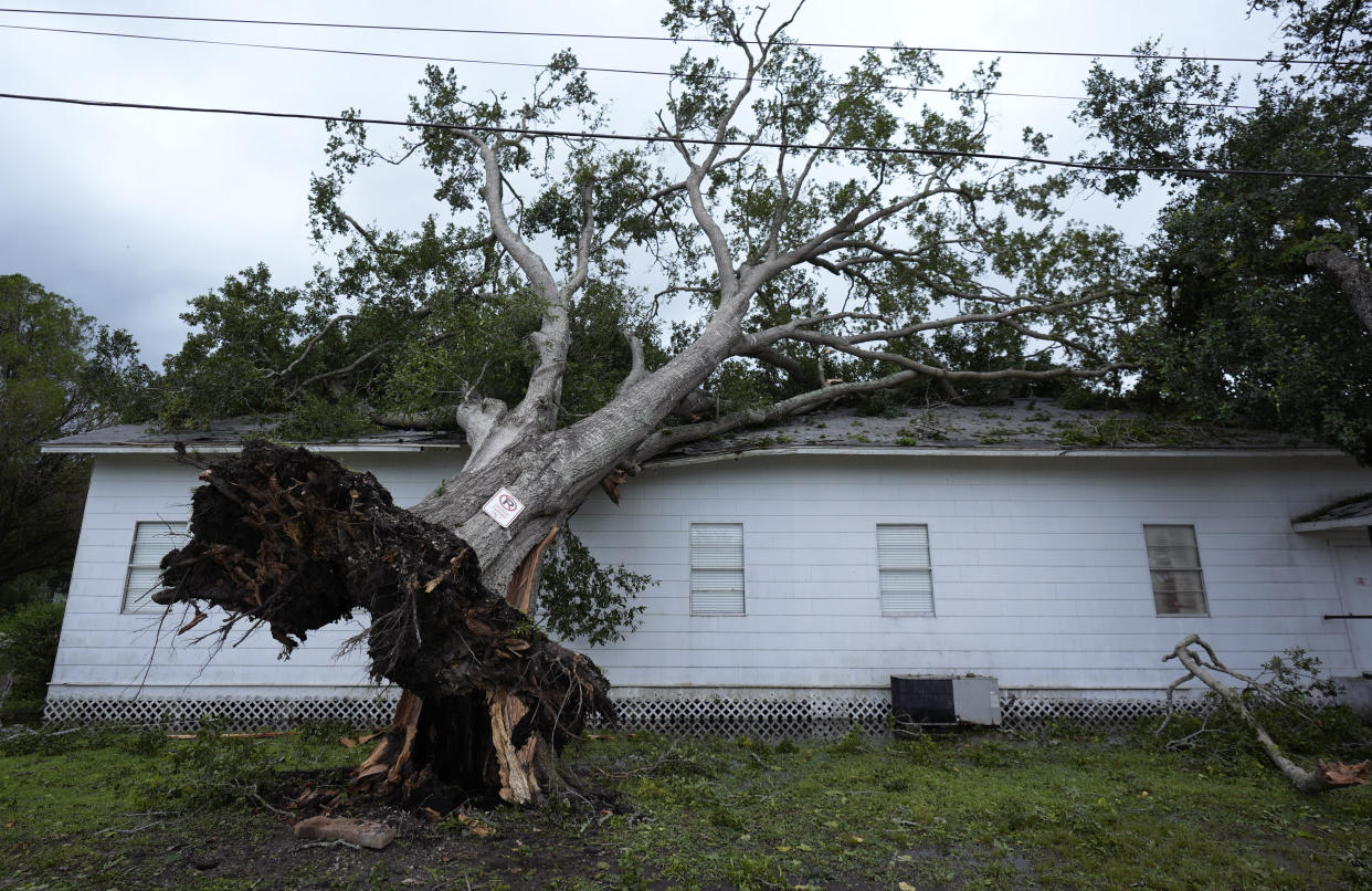 An upended tree rests on Bethel Church after Hurricane Beryl moved through Van Vleck, Texas, on Monday. 