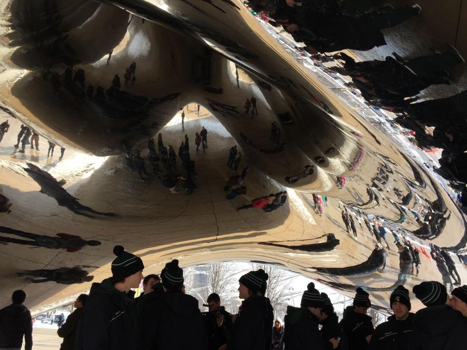 MSU hockey players stand below the sculpture “Cloud Gate” in Chicago’s Millennium Park on Saturday morning during the team’s pregame walk.