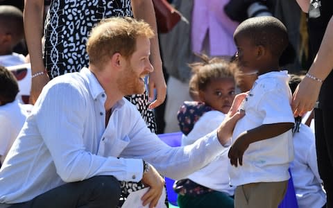 Prince Harry meets children in Nyanga township - Credit: PA