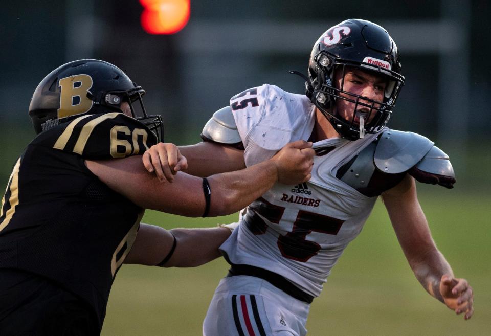 Boonville’s Gavin Maxey (60) tries to slow down Southridge's Luke Meyer (55) during their game at Bennett Field in Boonville, Ind., Friday night, Aug. 26, 2022. Southridge beat Boonville in a hot and humid dogfight 13-0.