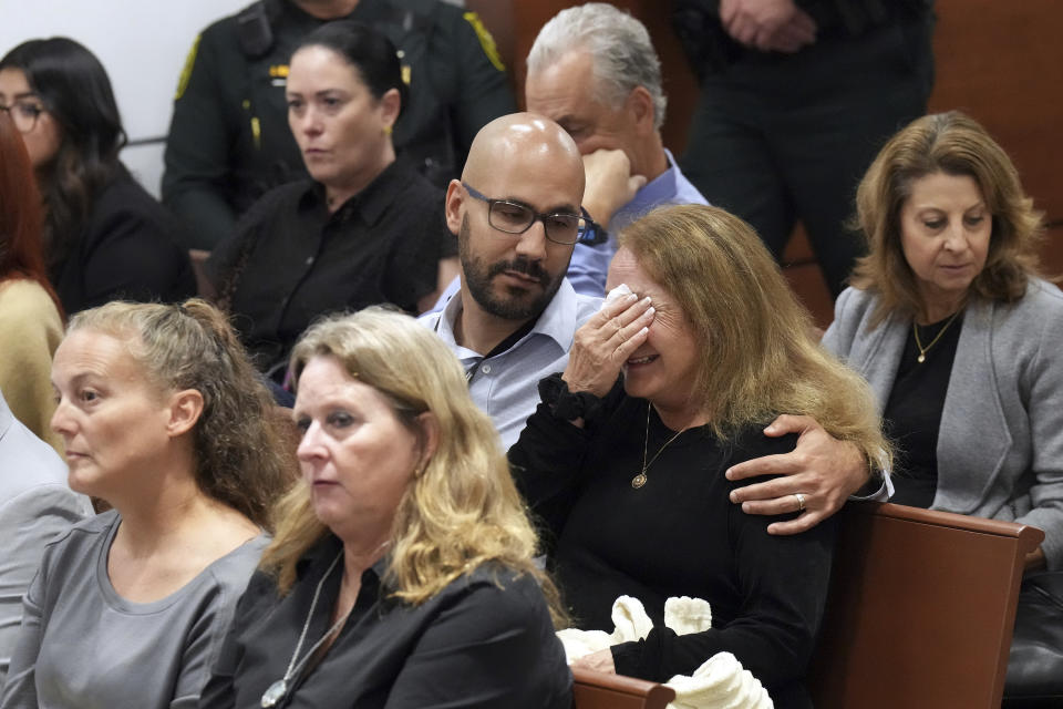 Teresa Robinovitz is consoled after presenting her victim impact statement in the sentencing hearing for Marjory Stoneman Douglas High School shooter Nikolas Cruz at the Broward County Courthouse in Fort Lauderdale, Fla. on Tuesday, Nov. 1, 2022. Robinovitz's granddaughter, Alyssa, was killed in the 2018 shootings. Cruz was sentenced to life in prison for murdering 17 people at Parkland's Marjory Stoneman Douglas High School more than four years ago. (Amy Beth Bennett/South Florida Sun Sentinel via AP, Pool)