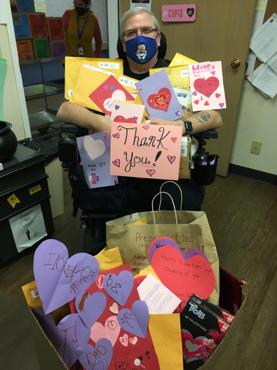 Gary Wright, a father of three who also has grandchildren and great-grandchildren, is surrounded by several Valentine's Day goodies sent to Spokane Veterans Home as part of its Valentines for Veterans program.