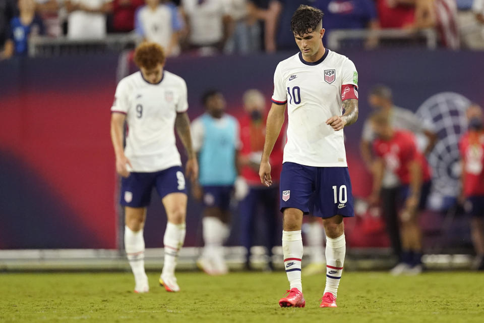 United States forwards Christian Pulisic (10) and Josh Sargent (9) leave the pitch following a 1-1 draw with Canada in a World Cup soccer qualifier Sunday, Sept. 5, 2021, in Nashville, Tenn. (AP Photo/Mark Humphrey)