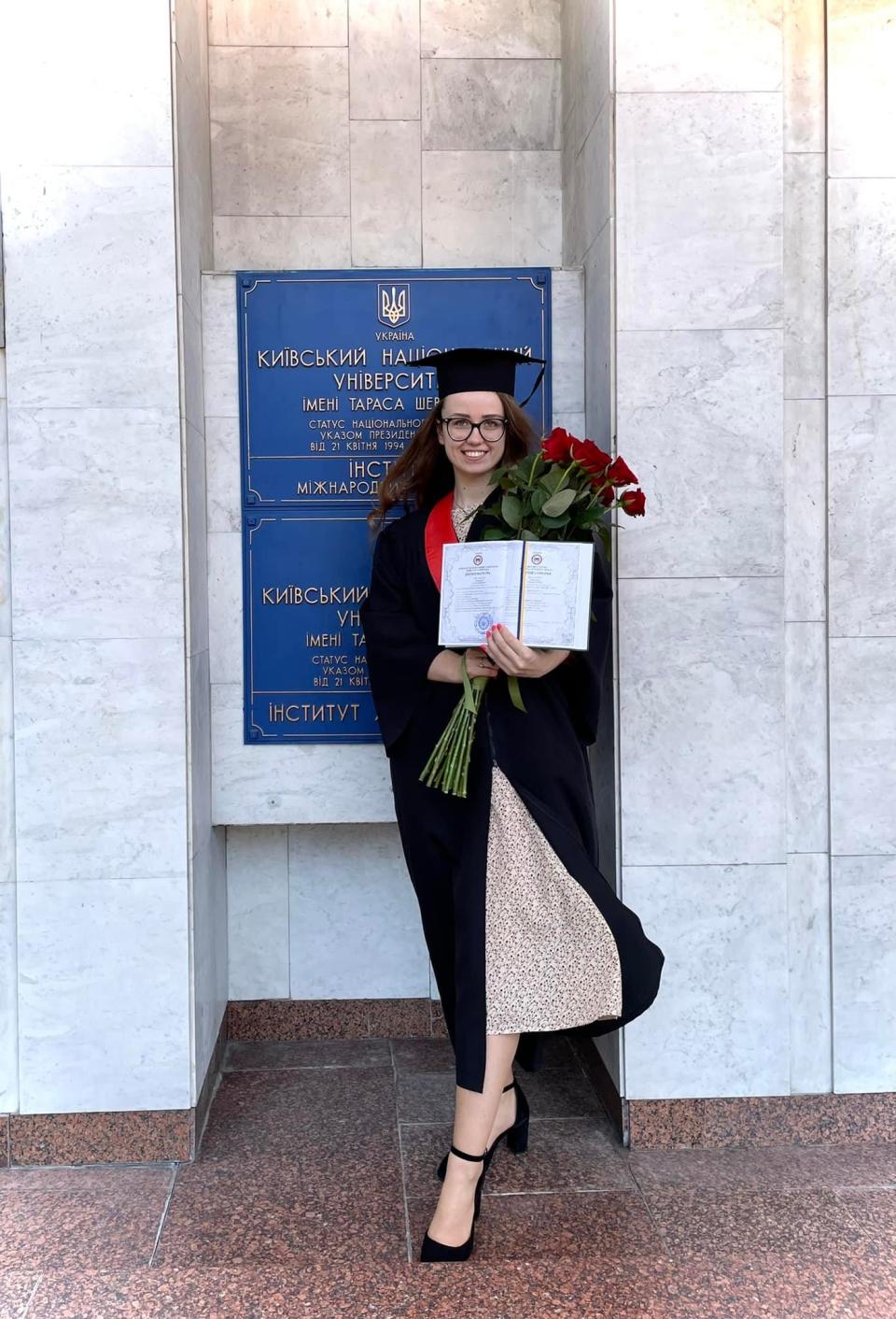 Ukrainian citizen and former Apponequet Regional High School exchange student Kateryna Solodovnyk stands outside of Taras Shevchenko National University of Kyiv after receiving her Master's Degree in International Law from the university's Educational and Scientific Institute of International Relations on June 20. Just four months prior, Solodovnyk and her fiance fled the city while facing the peril of an invading Russian military.