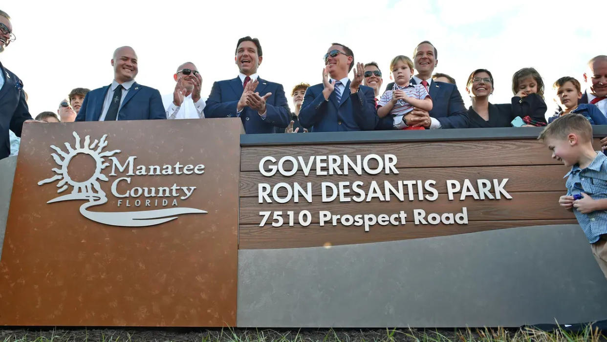 The Florida governor, center, attends the opening of Governor Ron DeSantis Park, in Manatee County, with local leaders. The park opened Oct. 18, 2023.